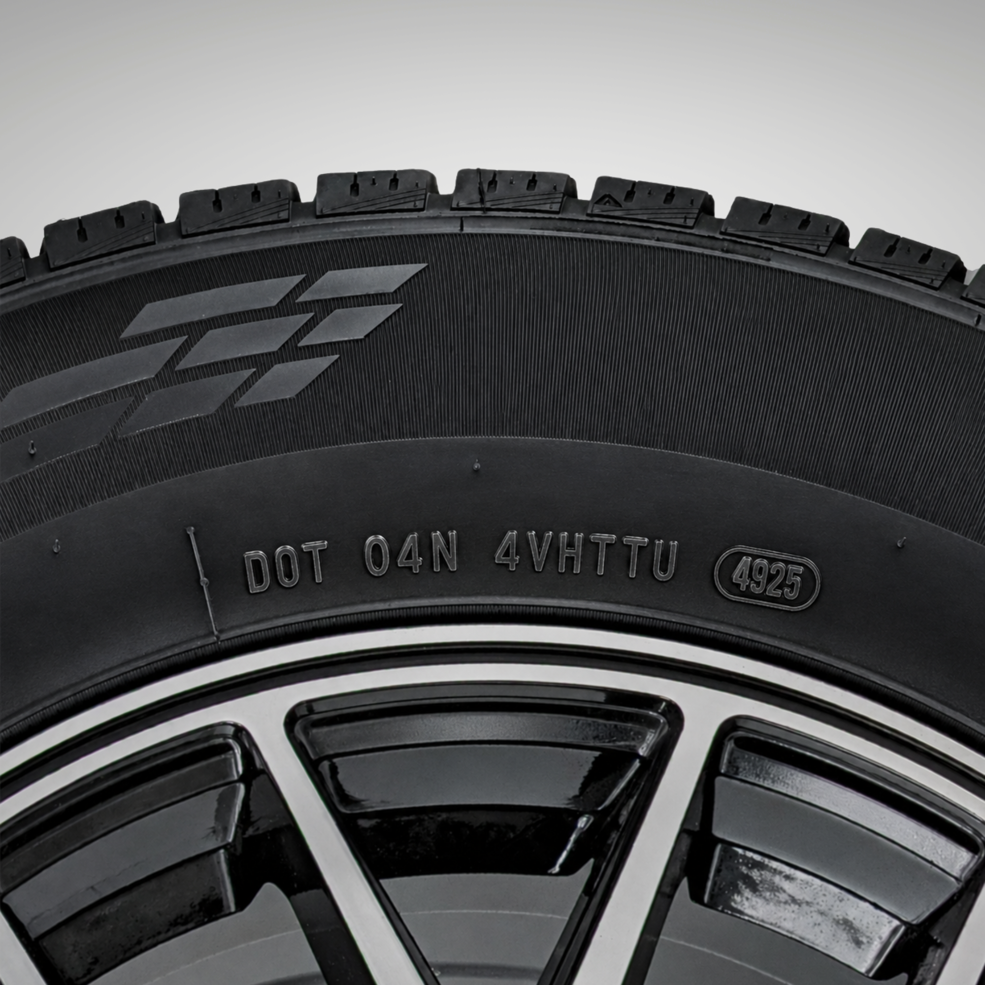 Close-up of a tire sidewall showing the DOT code location